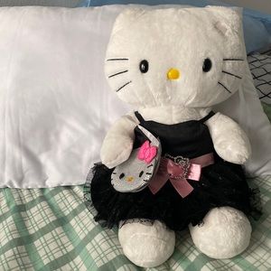 This is a white Hello kitty with a Hello kitty purse and Black Hello kitty dress